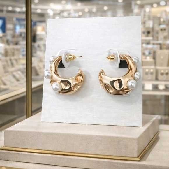 Jewelry - Gold earrings with pearl decor.